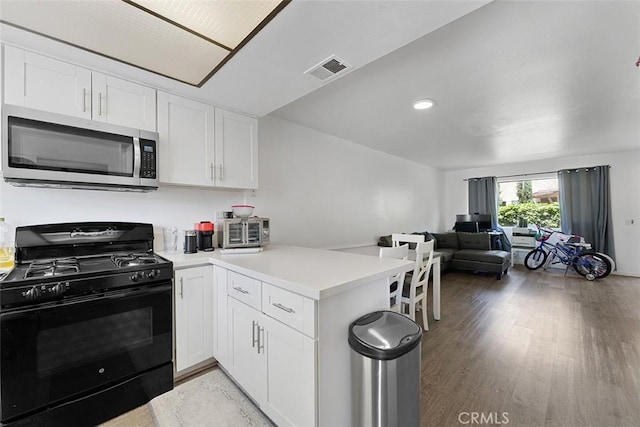 1553 Dennis Pl, West Covina, CA 91790 - kitchen featuring stainless steel microwave, black gas range, a peninsula, open floor plan, and light wood-type flooring