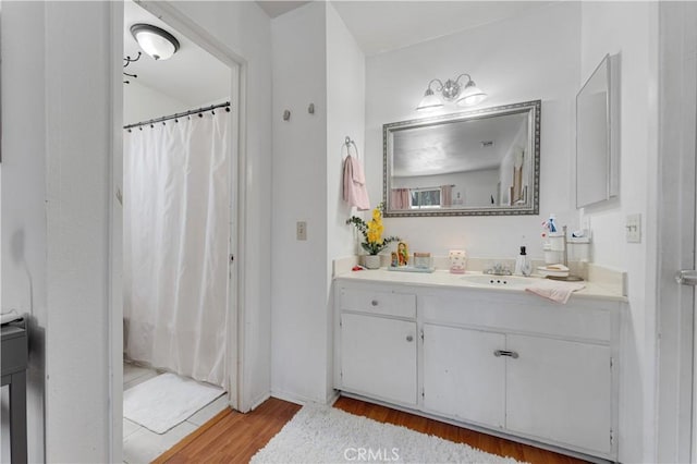 1553 Dennis Pl, West Covina, CA 91790 - full bathroom featuring vanity, wood finished floors, and a shower with shower curtain