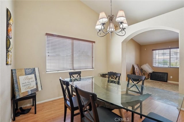 12671 Shorewood Ln, Victorville, CA 92392 - dining space featuring arched walkways, wood finished floors, and a chandelier
