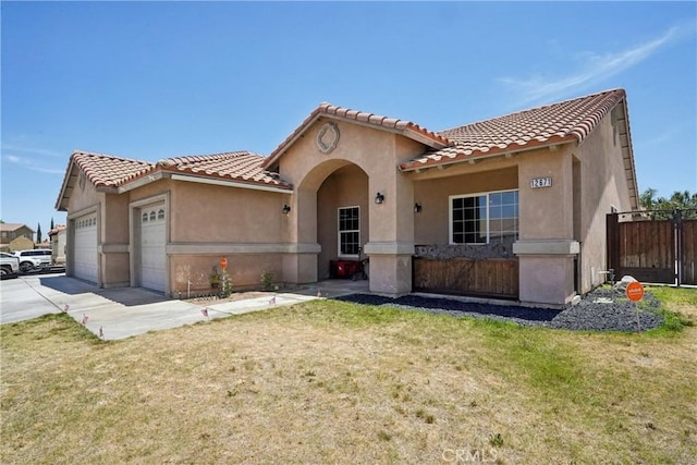 12671 Shorewood Ln, Victorville, CA 92392 - mediterranean / spanish-style home featuring an attached garage, concrete driveway, a tiled roof, and stucco siding