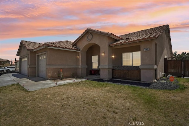 12671 Shorewood Ln, Victorville, CA 92392 - mediterranean / spanish-style home with concrete driveway, a garage, a tile roof, and stucco siding