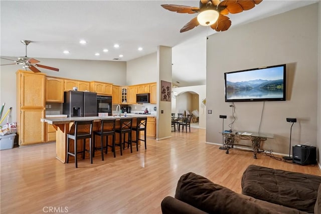 12671 Shorewood Ln, Victorville, CA 92392 - living room with a ceiling fan, arched walkways, high vaulted ceiling, light wood-style flooring, and recessed lighting