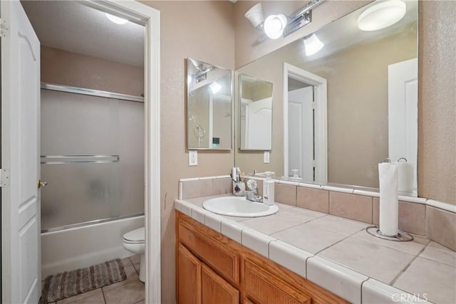 12671 Shorewood Ln, Victorville, CA 92392 - full bathroom with vanity, tile patterned floors, and enclosed tub / shower combo