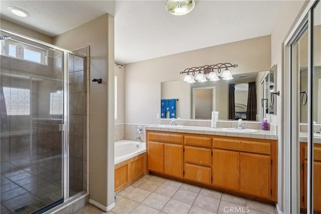 12671 Shorewood Ln, Victorville, CA 92392 - full bathroom with double vanity, a stall shower, tile patterned flooring, a garden tub, and a textured ceiling