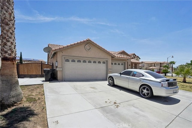 12671 Shorewood Ln, Victorville, CA 92392 - view of front of house featuring stucco siding, a garage, concrete driveway, and a tiled roof