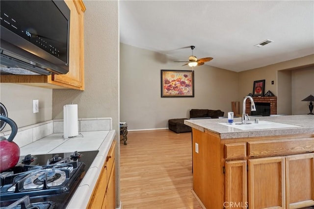 12671 Shorewood Ln, Victorville, CA 92392 - kitchen featuring light wood-style floors, a ceiling fan, and open floor plan