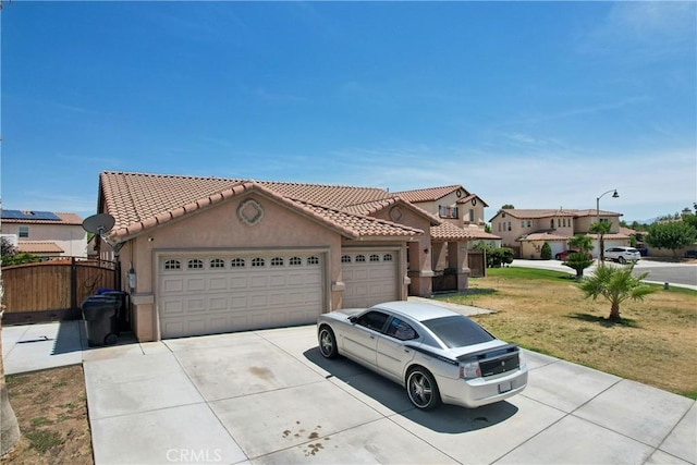 12671 Shorewood Ln, Victorville, CA 92392 - mediterranean / spanish house with a tile roof, driveway, stucco siding, and an attached garage