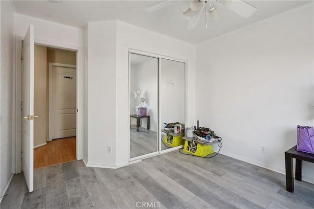 12671 Shorewood Ln, Victorville, CA 92392 - unfurnished bedroom featuring wood finished floors, a closet, and ceiling fan