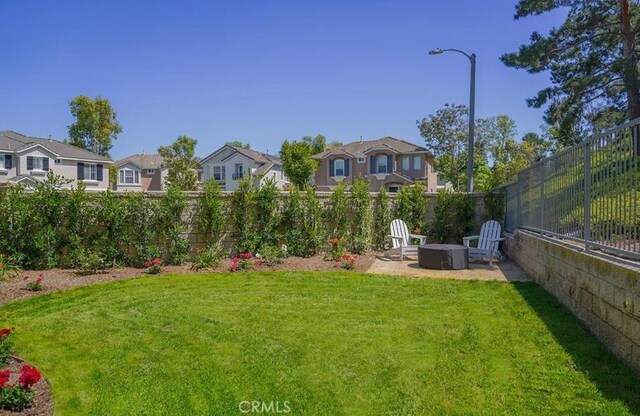 15 Parisville, Aliso Viejo, CA 92656 - fenced backyard featuring a residential view, a fire pit, and a patio