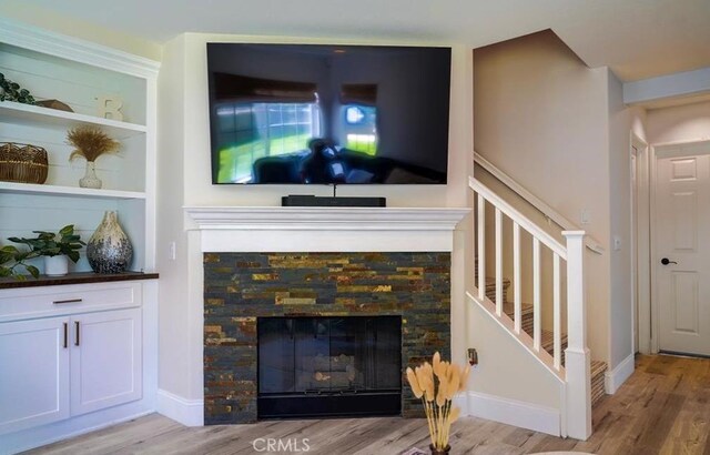 15 Parisville, Aliso Viejo, CA 92656 - living room featuring a fireplace, wood finished floors, and stairway