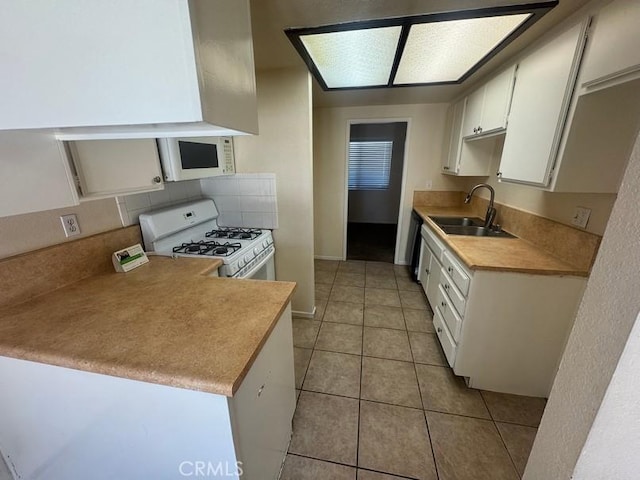 1848 Horizon Ln, Lancaster, CA 93535 - kitchen featuring white appliances, light tile patterned flooring, white cabinets, light countertops, and tasteful backsplash