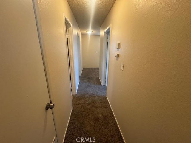 1848 Horizon Ln, Lancaster, CA 93535 - corridor with dark colored carpet, a textured ceiling, and a textured wall