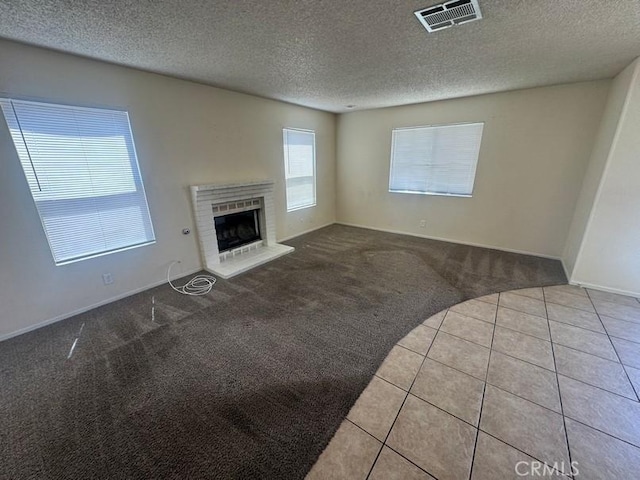 1848 Horizon Ln, Lancaster, CA 93535 - unfurnished living room featuring carpet flooring, a textured ceiling, a brick fireplace, and tile patterned floors
