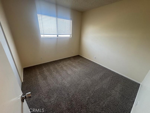 1848 Horizon Ln, Lancaster, CA 93535 - spare room featuring a textured ceiling and dark colored carpet