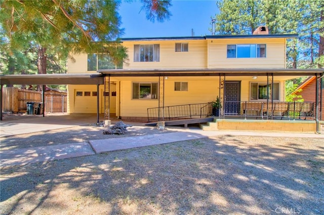 960 Snowbird Rd, Wrightwood, CA 92397 - view of front of home with a chimney, a porch, driveway, and an attached carport