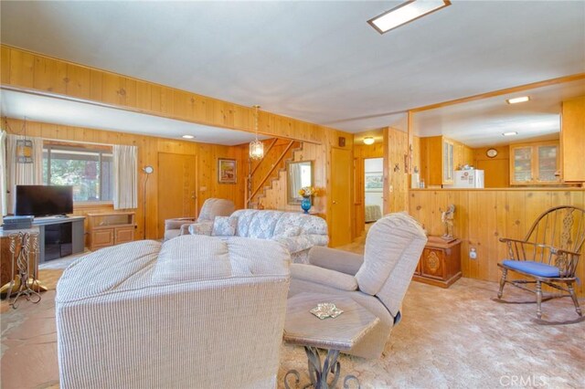 960 Snowbird Rd, Wrightwood, CA 92397 - carpeted living room with wooden walls and stairway