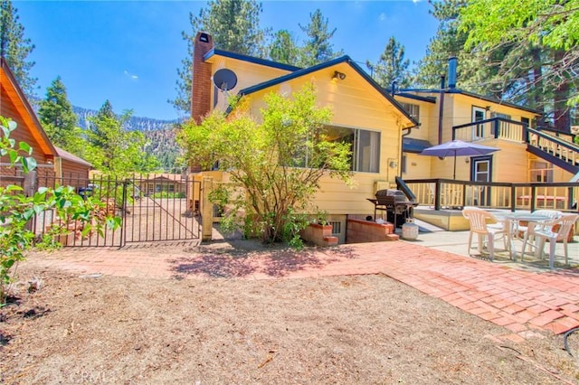 960 Snowbird Rd, Wrightwood, CA 92397 - back of house featuring a chimney, a gate, and a patio
