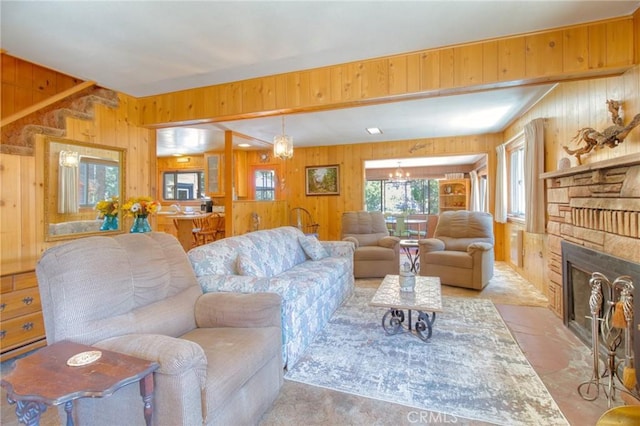 960 Snowbird Rd, Wrightwood, CA 92397 - living area with wood walls, a fireplace with flush hearth, and a chandelier
