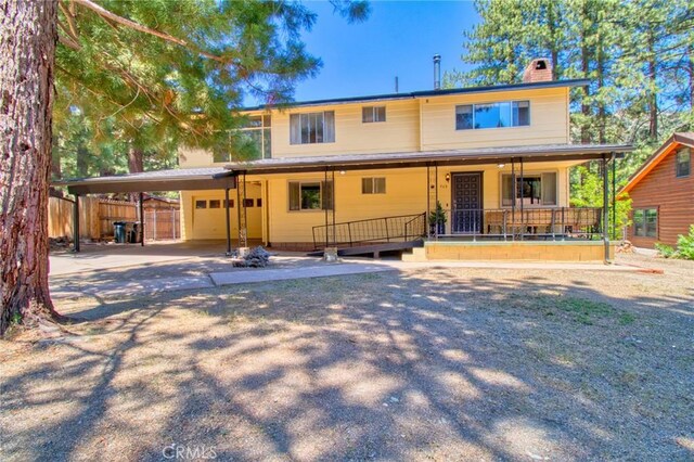 960 Snowbird Rd, Wrightwood, CA 92397 - view of front of property with a chimney, covered porch, an attached carport, and concrete driveway