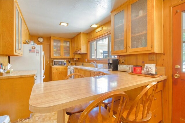 960 Snowbird Rd, Wrightwood, CA 92397 - kitchen with white appliances, glass insert cabinets, plenty of natural light, light countertops, and wood walls