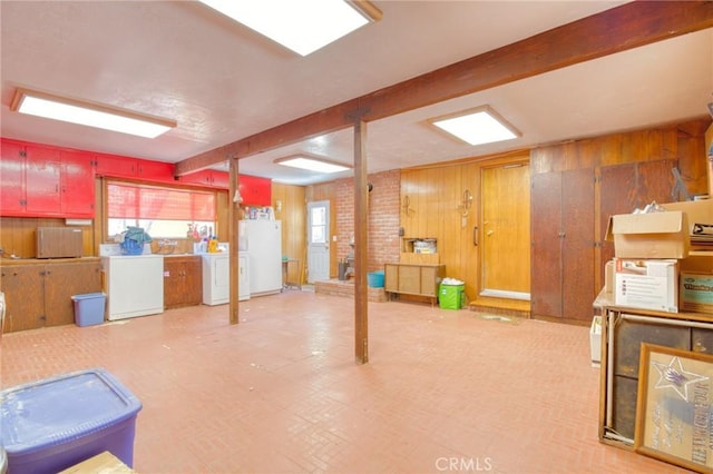960 Snowbird Rd, Wrightwood, CA 92397 - below grade area with washer and dryer, freestanding refrigerator, wooden walls, and light flooring