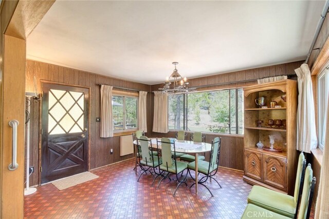 960 Snowbird Rd, Wrightwood, CA 92397 - dining room featuring wood walls, tile patterned floors, and a chandelier