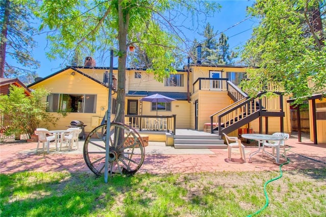 960 Snowbird Rd, Wrightwood, CA 92397 - rear view of house featuring a patio area, a deck, and a chimney