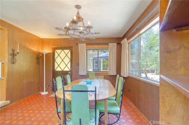 960 Snowbird Rd, Wrightwood, CA 92397 - dining space featuring wooden walls, tile patterned floors, and a chandelier