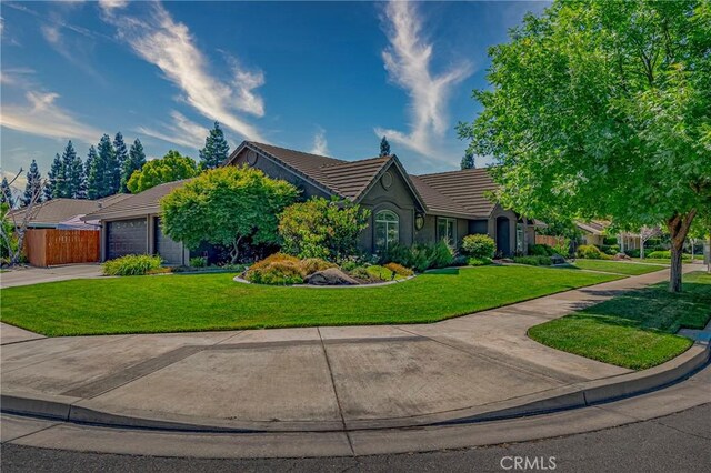 3486 Cascade Creek Ave, Merced, CA 95340 - view of front of house featuring a tiled roof, driveway, an attached garage, and stucco siding