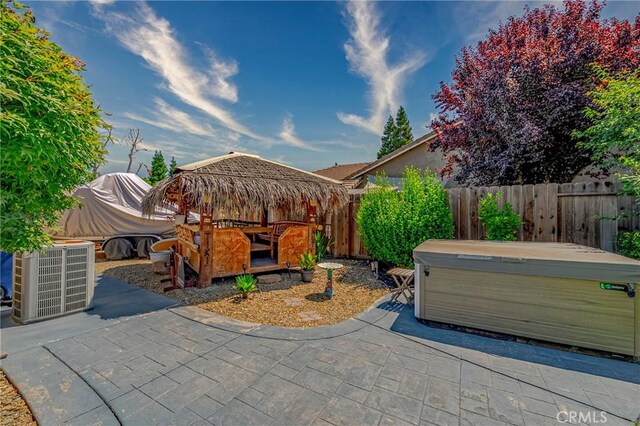 3486 Cascade Creek Ave, Merced, CA 95340 - fenced backyard with a hot tub and a patio area