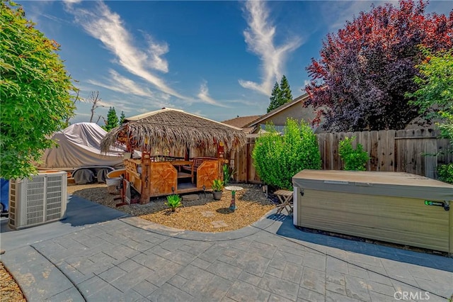 3486 Cascade Creek Ave, Merced, CA 95340 - fenced backyard featuring a hot tub and a patio area