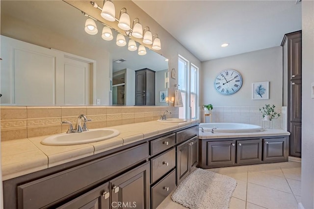 3486 Cascade Creek Ave, Merced, CA 95340 - bathroom with double vanity, a bath, tile patterned floors, decorative backsplash, and a shower with door