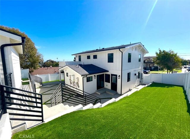 624 W 38th St, San Pedro, CA 90731 - rear view of property featuring board and batten siding, a fenced backyard, and a patio