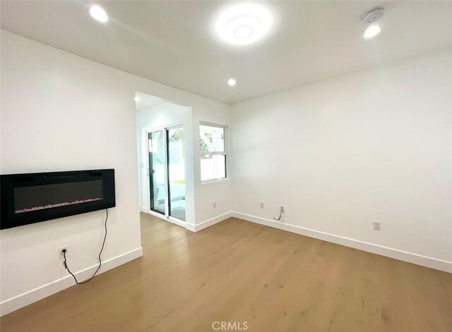 624 W 38th St, San Pedro, CA 90731 - unfurnished living room featuring wood finished floors, a glass covered fireplace, and recessed lighting