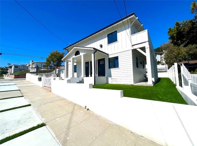 624 W 38th St, San Pedro, CA 90731 - back of house featuring board and batten siding, a porch, and a balcony