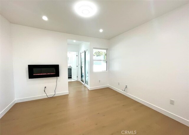 624 W 38th St, San Pedro, CA 90731 - unfurnished living room with a glass covered fireplace, wood finished floors, and recessed lighting