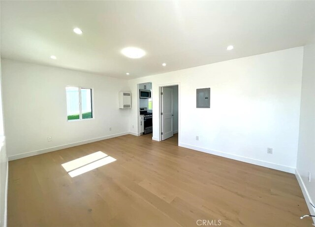 624 W 38th St, San Pedro, CA 90731 - unfurnished living room featuring electric panel, light wood-type flooring, and recessed lighting