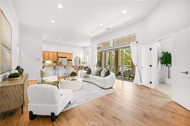 83 City Stroll, Irvine, CA 92620 - living area featuring recessed lighting, a high ceiling, and light wood-style flooring