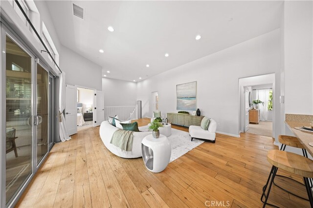 83 City Stroll, Irvine, CA 92620 - living area with a towering ceiling, light wood finished floors, and recessed lighting