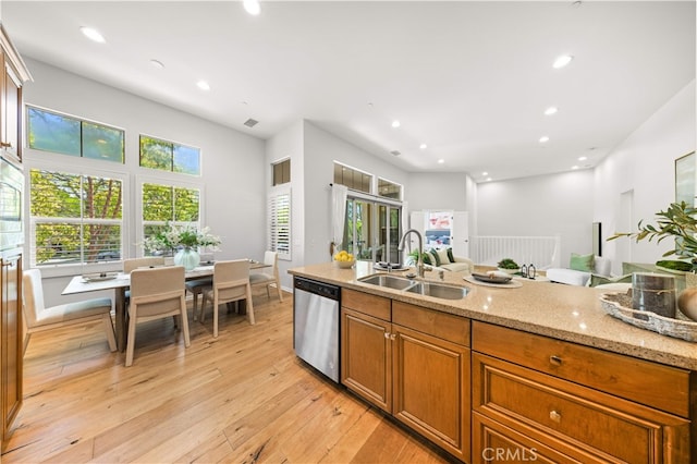 83 City Stroll, Irvine, CA 92620 - kitchen with stainless steel dishwasher, brown cabinetry, light wood-style flooring, light stone countertops, and recessed lighting