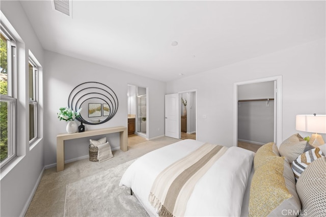 83 City Stroll, Irvine, CA 92620 - bedroom featuring multiple windows, light carpet, connected bathroom, and a walk in closet