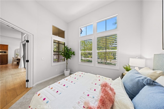 83 City Stroll, Irvine, CA 92620 - bedroom featuring a high ceiling and light wood-style flooring