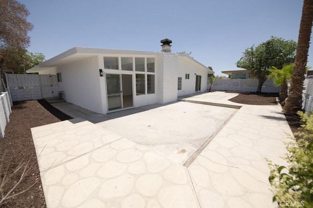 14163 Wimbleton Dr, Victorville, CA 92395 - rear view of house with a patio, a fenced backyard, and stucco siding
