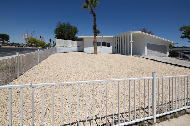 14163 Wimbleton Dr, Victorville, CA 92395 - view of front of property with concrete driveway, stucco siding, and a garage