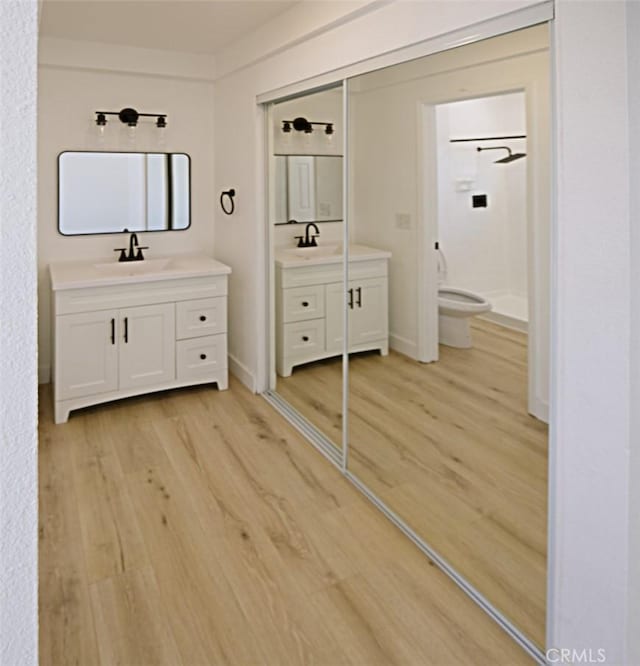 14163 Wimbleton Dr, Victorville, CA 92395 - full bathroom with wood finished floors, a shower stall, and two vanities