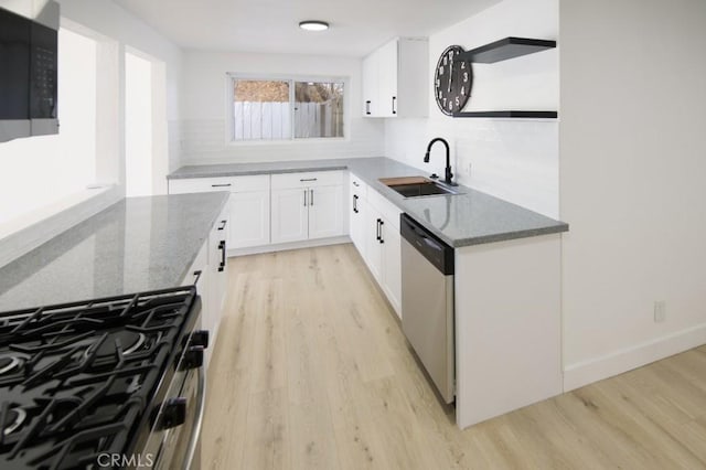 14163 Wimbleton Dr, Victorville, CA 92395 - kitchen with appliances with stainless steel finishes, dark stone counters, light wood-type flooring, and decorative backsplash
