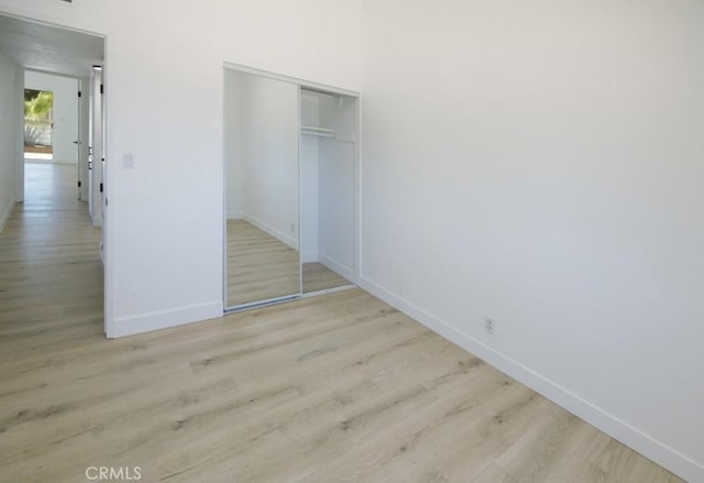 14163 Wimbleton Dr, Victorville, CA 92395 - unfurnished bedroom featuring wood finished floors and a closet