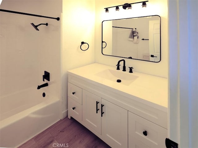 14163 Wimbleton Dr, Victorville, CA 92395 - full bathroom with wood finished floors, vanity, and washtub / shower combination