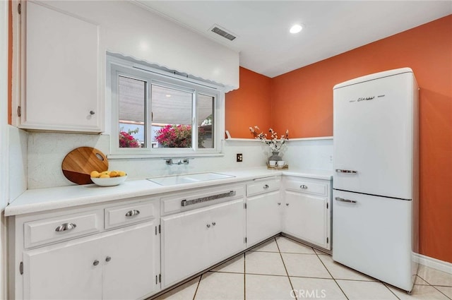 5855 Lemon Ave, Long Beach, CA 90805 - kitchen featuring freestanding refrigerator, white cabinetry, light countertops, light tile patterned flooring, and recessed lighting
