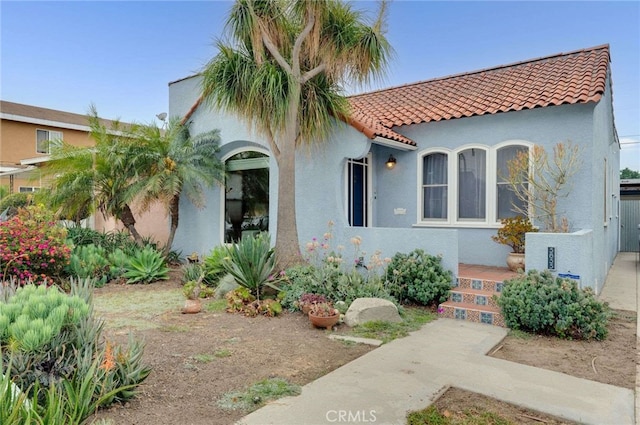 5855 Lemon Ave, Long Beach, CA 90805 - mediterranean / spanish home featuring a tile roof and stucco siding
